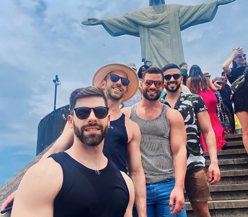 Group of friends at Christ the Redeemer, Rio de Janeiro - LGBTQ+ travel experience with Velvet