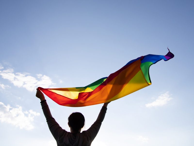 Young woman with LGBT flag.